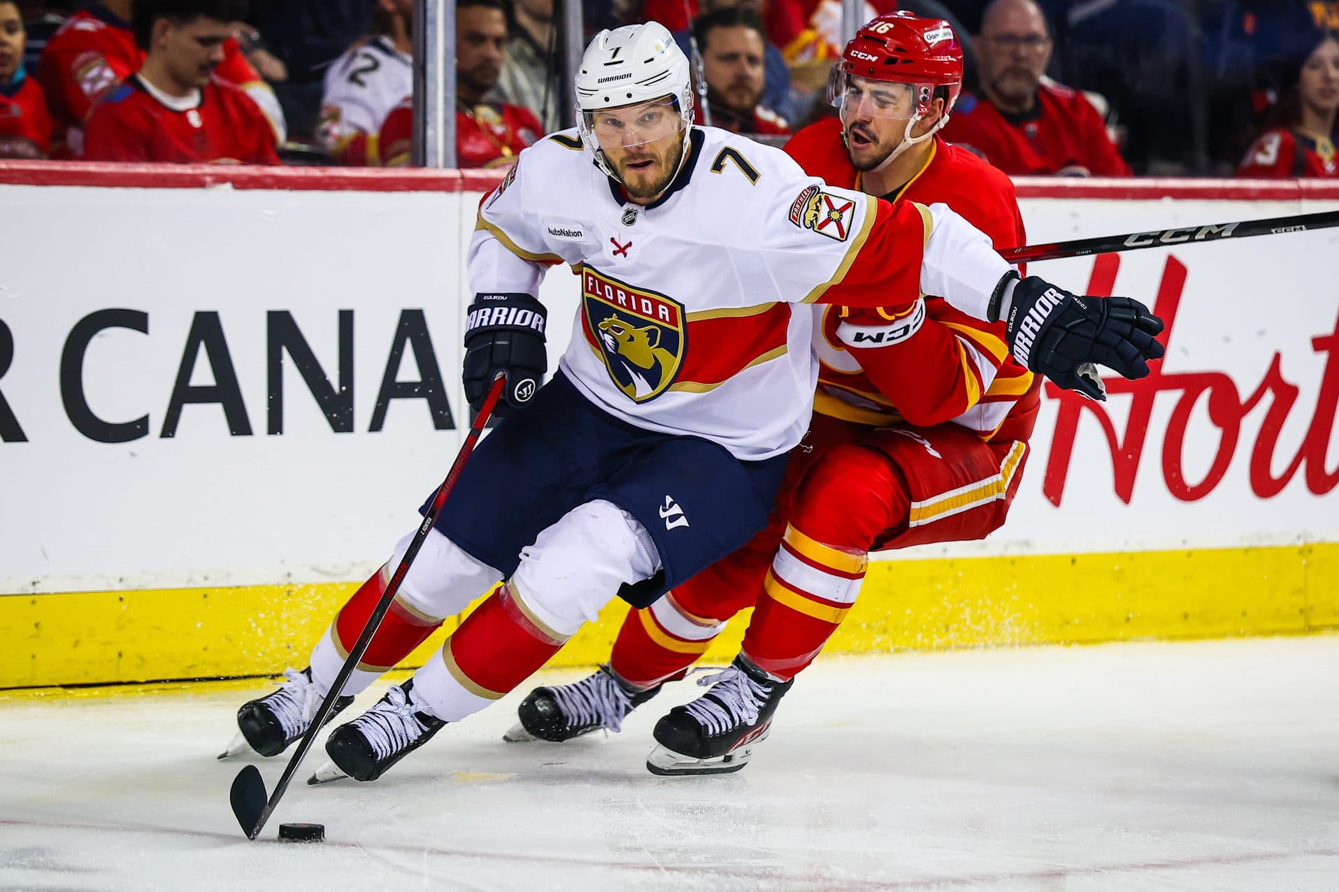 Florida Panthers defenseman Dmitry Kulikov (7) controls the puck against Calgary Flames center Morgan Frost (16) during the second period at Scotiabank Saddledome.
