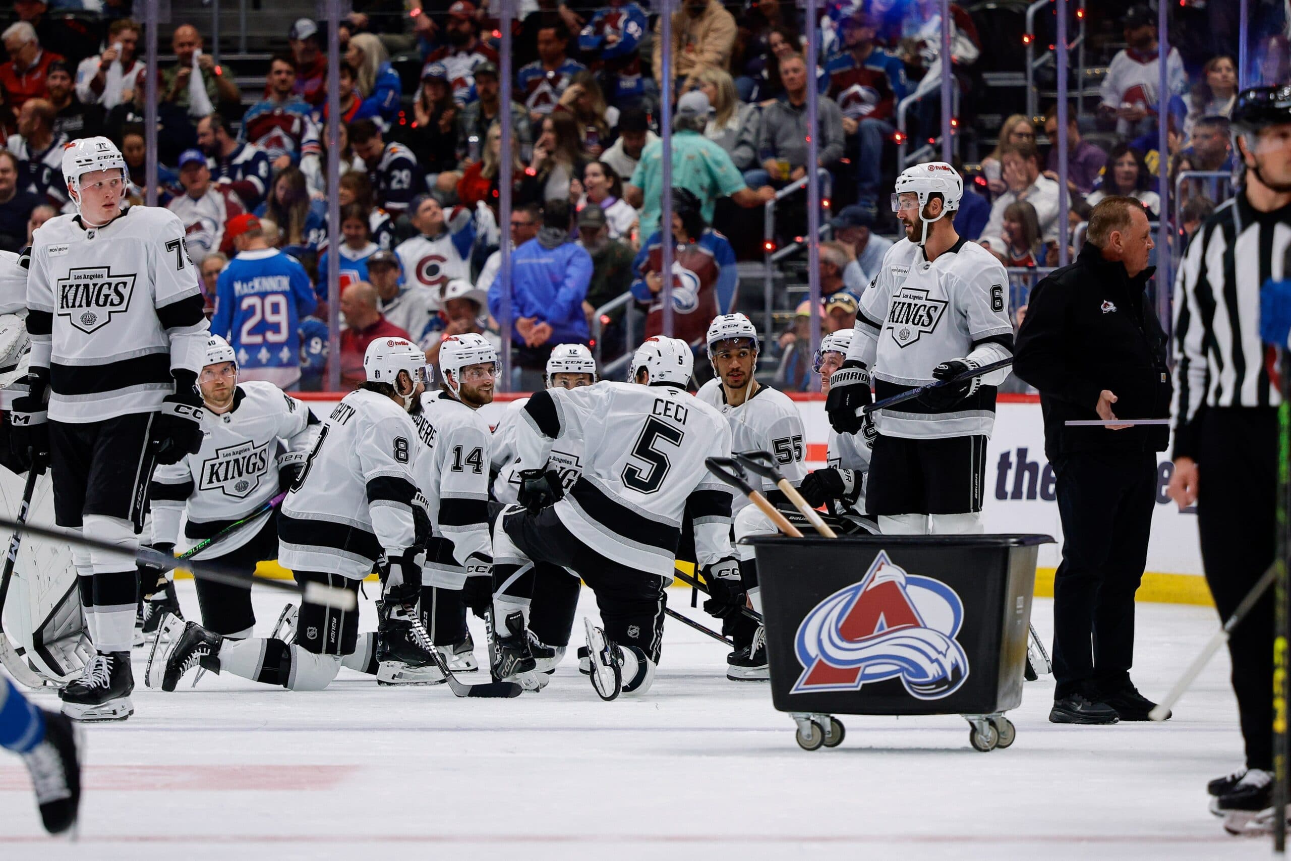 Los Angeles Kings players wait as the glass is changed behind their bench in the second period against the Colorado Avalanche in game two of the first round of the 2026 Stanley Cup Playoffs at Ball Arena.