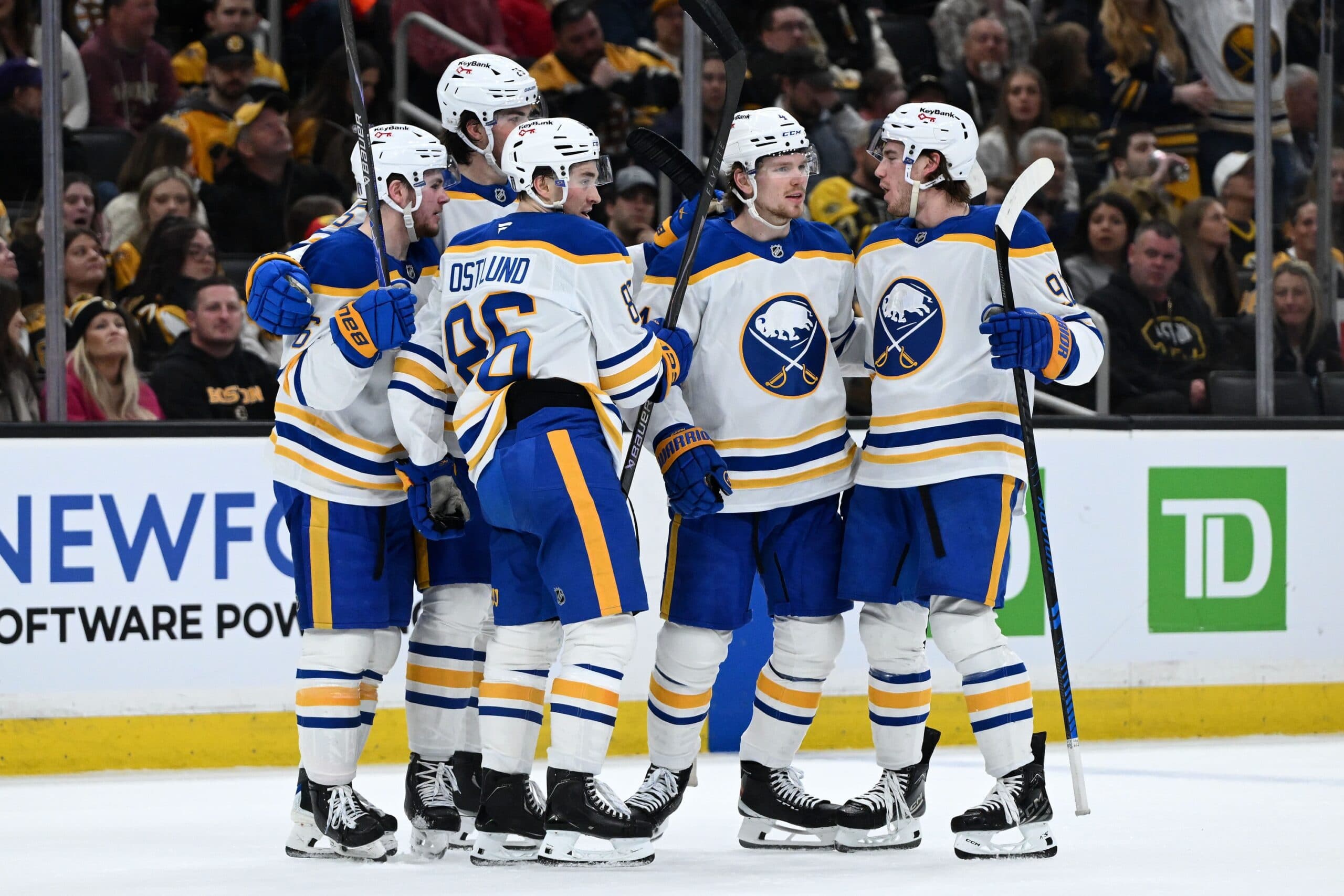Buffalo Sabres defenseman Bowen Byram (4) celebrates with his teammates after scoring a goal against the Boston Bruins during the second period of game three of the first round of the 2026 Stanley Cup Playoffs at the TD Garden.