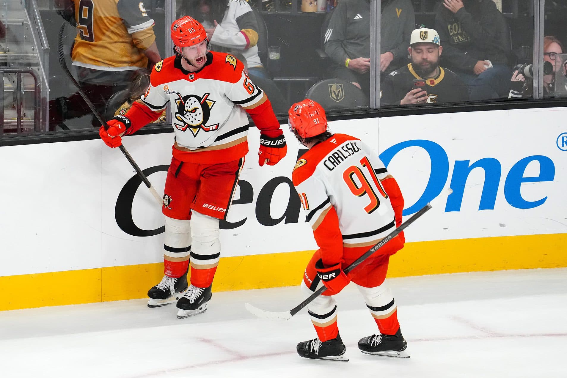 Anaheim Ducks defenseman Jacob Trouba (65) celebrates with Anaheim Ducks center Leo Carlsson (91) after scoring a goal against the Vegas Golden Knights during an overtime period to give the Ducks a 4-3 victory at T-Mobile Arena.